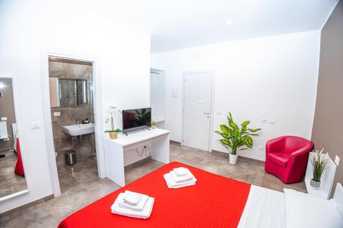a white bathroom with a red bed and a sink at suebi rooms and appartament in Termoli