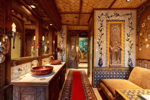a bathroom with two sinks and a couch in a train at The Inn of Five Graces in Santa Fe