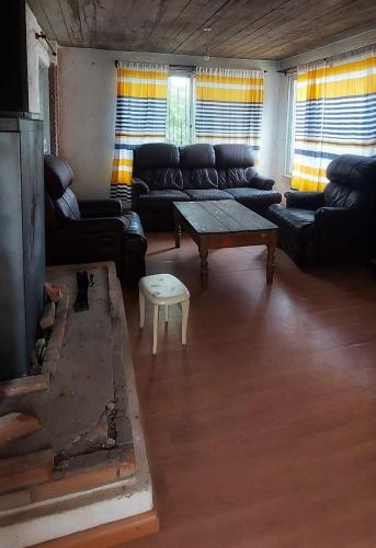 a living room with a couch and a coffee table at Cabañas Virazon Aguas Dulces in Aguas Dulces