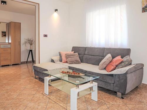 a living room with a couch and a glass table at Holiday Home Villa Desanka by Interhome in Kršan