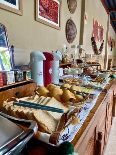 a buffet with bread and other food on a table at Hotel Casa do Bispo in Manaus