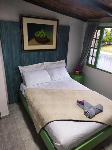 a bedroom with a large bed with towels on it at Finca San Alejandro in Cotacachi