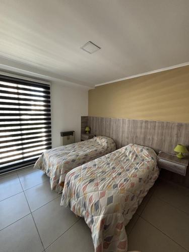 Ένα ή περισσότερα κρεβάτια σε δωμάτιο στο Departamento Centro