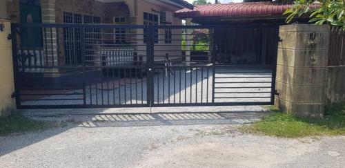 a gate in front of a house at Zafhomestay Kuala Terengganu in Kampong Batu Burok