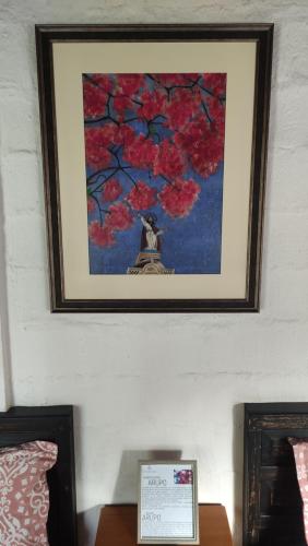 a picture on a wall with a picture of a tree at Finca San Alejandro in Cotacachi