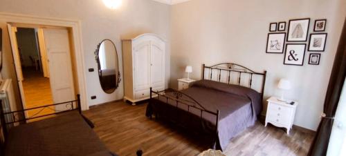a bedroom with a bed and a hallway with a mirror at Casa Principe Taranto "Intero appartamento" in Taranto
