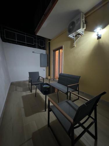 a room with chairs and a table and a window at La Chic Maison in Corbara