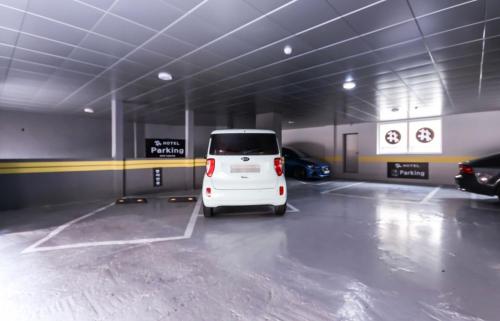 a white van parked in a parking garage at The Sharp Hotel in Changwon