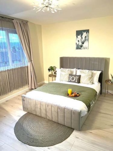 a bedroom with a large bed with a tray on it at The Art Gallery Guest House - Newport Cozy 3-Bedroom Home in Newport