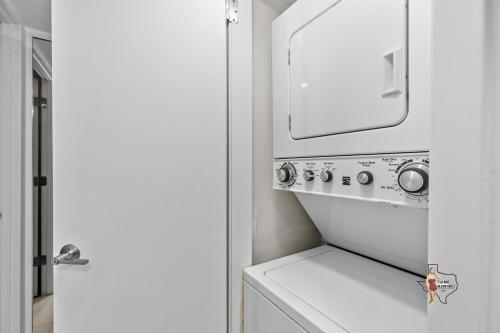 a white washer and dryer in a small kitchen at Bahia Mar Solare Beachfront Resort Condos with Two Pools in South Padre Island