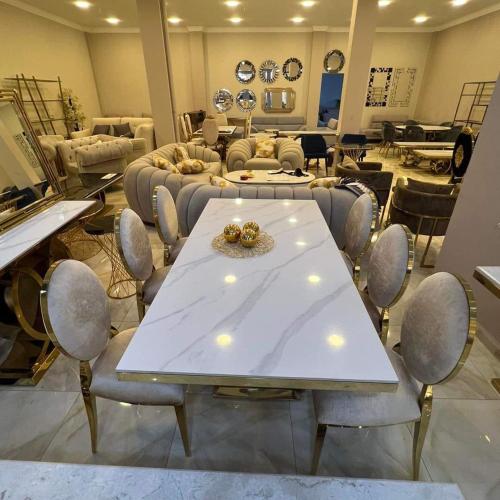 a salon with a table and chairs in a room at LES RÉSIDENCES DE DJIBRIL in Le Blanc-Mesnil