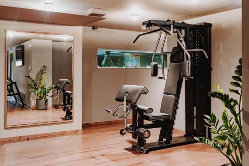 a fitness room with a gym with a mirror at AMERON Zürich Bellerive au Lac in Zürich