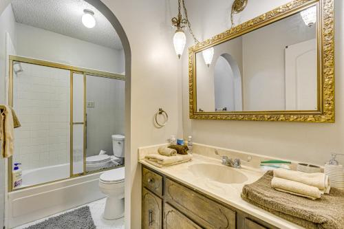 a bathroom with a sink and a toilet and a mirror at 8 Mi to Downtown Little Rock Home with Patio in Little Rock