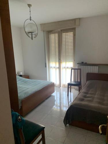 Ένα ή περισσότερα κρεβάτια σε δωμάτιο στο Appartamento zona centrale con barbecue