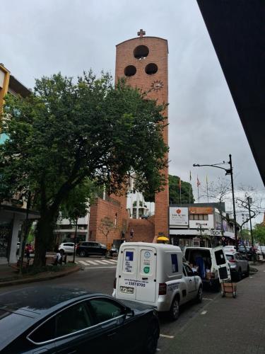 a truck parked in front of a clock tower at AP com cama King size e 2 colchão no chão e Internet no centro de Blu in Blumenau