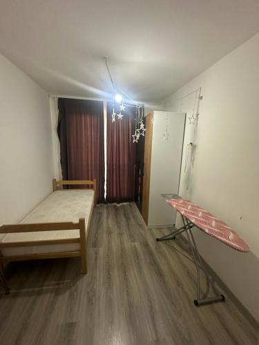 a room with a bed and a table in it at Fushe kosove pristina daire otel apart in Kosovo Polje