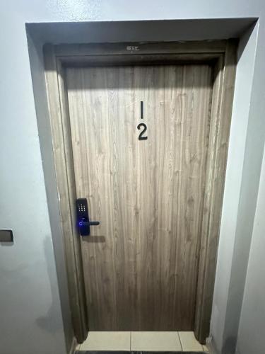 a wooden door with the number one on it at charming room close to Marrakech airport in Marrakech