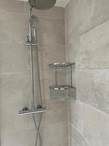 a shower with two shelves in a bathroom at Apartament BOIX de Molló Parc in Molló