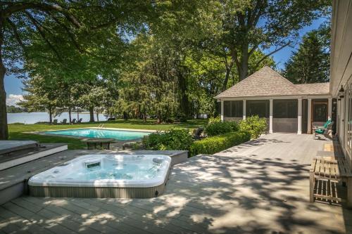 a hot tub on a patio next to a house at Baydream Believer in Saint Michaels