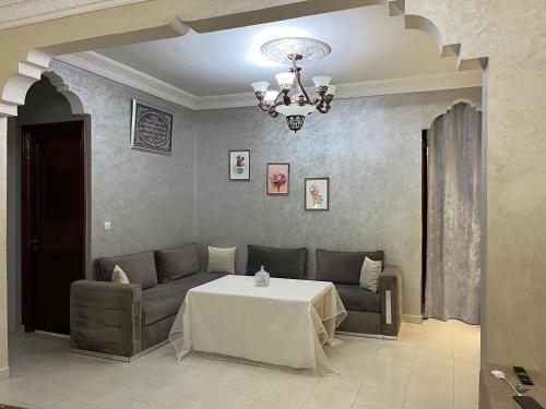 a living room with a couch and a table at شقة مفروشة تطل على طبيعة جميييلة in Ouazzane