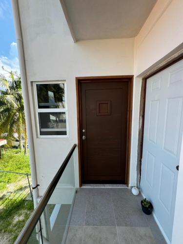 a door to a house with a porch at Apartamento cerca del mar in Puerto Morelos
