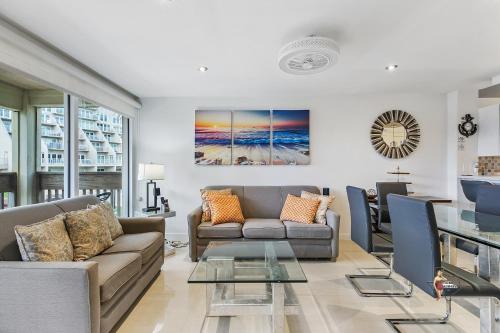 a living room with a couch and a glass table at Bahia Mar Solare Beachfront Resort Condos with Two Pools in South Padre Island