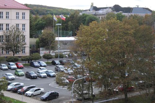 a parking lot full of cars in a city at Sun Apartment in Teplice