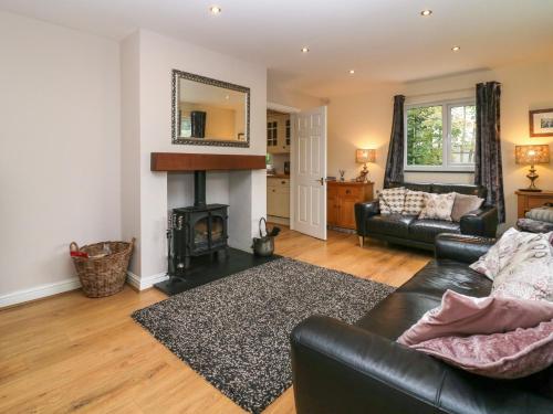 a living room with a couch and a fireplace at Inglenook in Ulverston