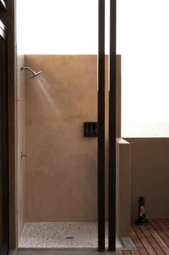 a shower stall in a bathroom with a window at Marepe Mountain View in Kampersrus AH