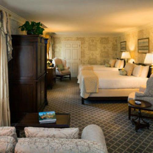 a hotel room with a bed and a couch at Williamsburg Inn, an official Colonial Williamsburg Hotel in Williamsburg