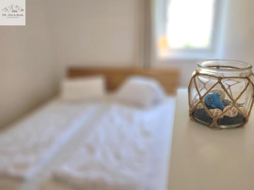 a glass jar with a bird in it sitting on a table at Alpine Tauplitz TOP 5 in Tauplitz
