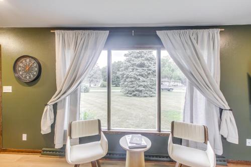 a window with two chairs and a table and a clock at Updated Plymouth Home about 5 Mi to Road America! in Plymouth