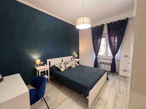 a bedroom with a bed and a blue wall at A casa di Pina - Roma St Peter in Rome