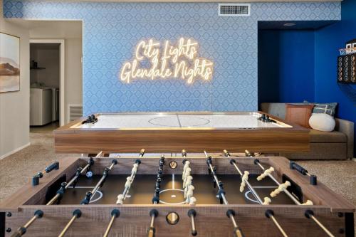 a room with a bed with a bunch of baseball bats at Glendale Nights - Pool Hot Tub Put Put Foosball in Glendale