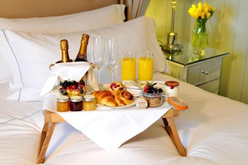 a tray of food and drinks on a bed at Eleni Palace in Amoudara Herakliou