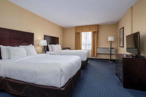 a hotel room with two beds and a flat screen tv at Comfort Inn - Gander in Gander