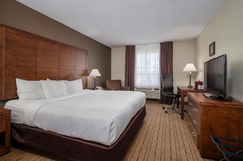 a hotel room with a bed and a flat screen tv at Comfort Inn - Gander in Gander