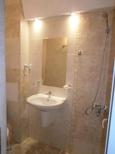a bathroom with a sink and a shower at Family Hotel White House in Pomorie