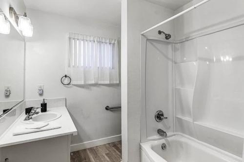 a white bathroom with a sink and a shower at Cozy 1 Bed Sleeps 4! Near Strip Perfect GetAway! in Las Vegas