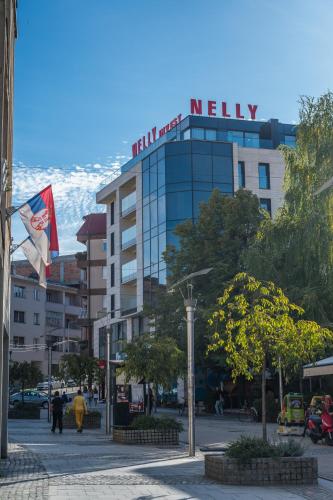 a hotel with a sign on top of a building at Monelly apartments Loznica - pešačka zona in Loznica