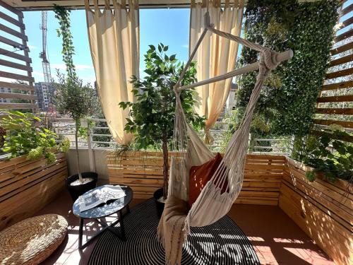a hammock on a balcony with plants at Apartments Wroc'LOVE by me & Mosiężna & Free Garage & Self Check in 24H in Wrocław