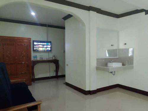 a bathroom with a sink and a counter in a room at Balai Mariacaria Pension House in Guindulman