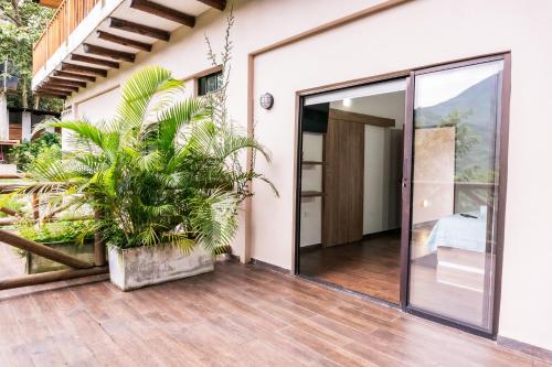 a house with a glass door and a plant at Cabaña de lujo en la montaña in Santa Marta