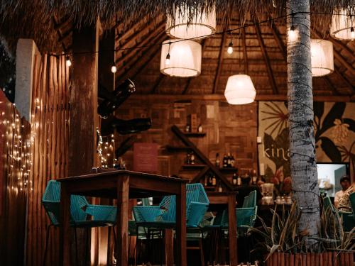 a restaurant with blue chairs and a table and lights at Khaban Bacalar Hotel Boutique in Bacalar