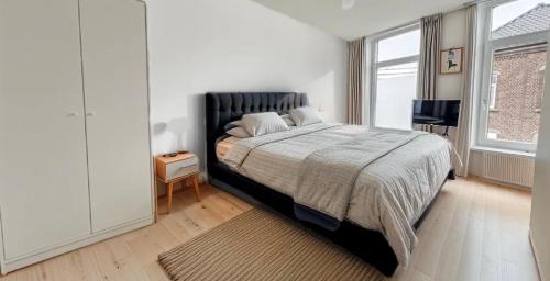 a bedroom with a bed and a large window at Charbex 2 Bruxelles-Charleroi-airport in Charleroi