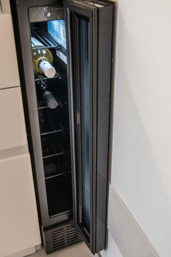 a black refrigerator with its door open in a kitchen at Appartamenti Aurelia 89 in Nardò
