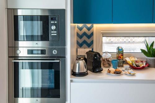 a kitchen with a stainless steel oven and a microwave at Appartamenti Aurelia 89 in Nardò
