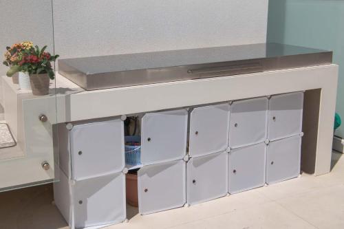 a kitchen counter with white cabinets and a sink at Appartamenti Aurelia 89 in Nardò