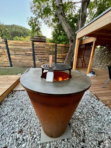 a fire pit in a yard next to a deck at Apartmány pod Janovským vŕškom in Plavecký Svätý Mikuláš