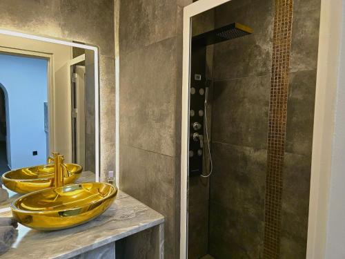 a bathroom with a yellow sink and a shower at Rentcenter79 in Donawitz